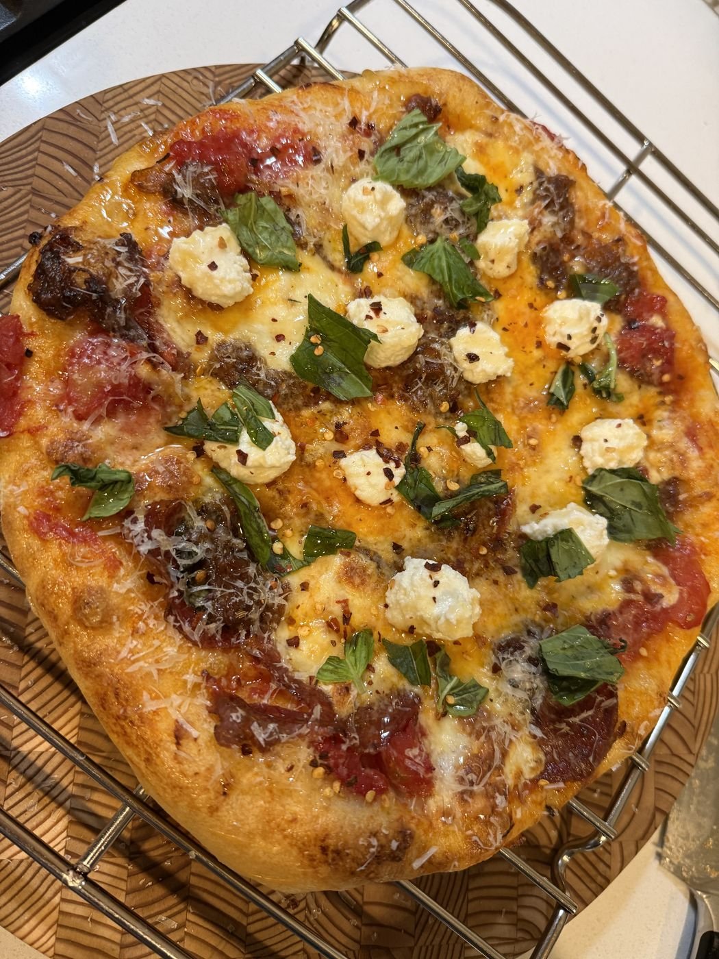 Homemade pizza with ricotta, basil and sausage
